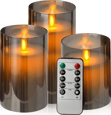 Three LED candles in glass holders with a remote control in the foreground.