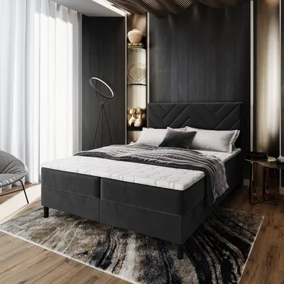 A bedroom scene featuring a bed, rug, and decorative elements.