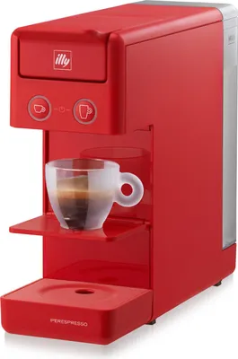 A red Illy espresso machine with a cup of espresso on the drip tray.