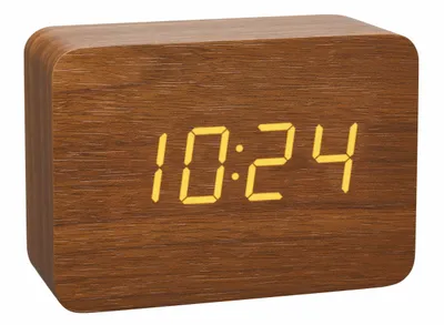 A digital clock with a wood-grain finish displays the time.