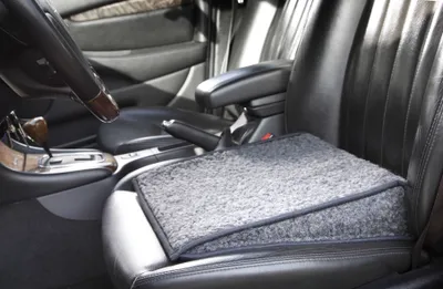 Interior of a car with a gray seat cushion on the driver's seat.