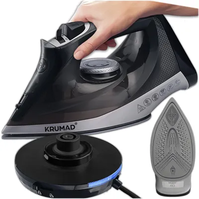 A hand is holding a black and silver cordless iron, with a charging base and the soleplate of the iron shown separately.