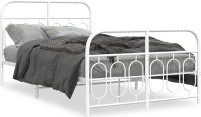 A white metal bed frame with bedding.