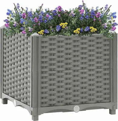 A gray woven planter box filled with colorful flowers.