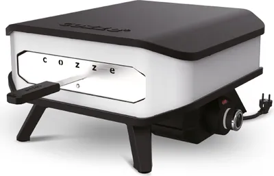 A white and black electric pizza oven with a pizza peel inserted into the opening, shown on a white background.