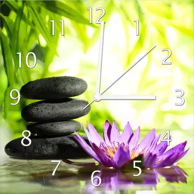 Produktbild von Wallario Design Wanduhr Steinstapel in schwarz mit Blumenblüte in lila aus Echtglas, Größe 30 x 30 cm