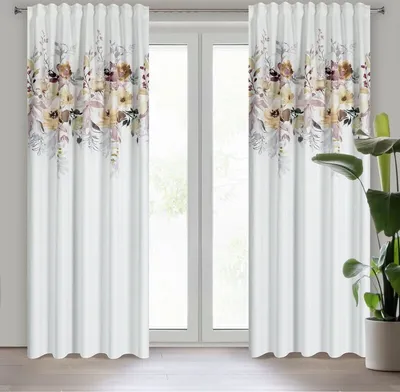 Two white curtains with a floral pattern at the top, hanging in front of a window.
