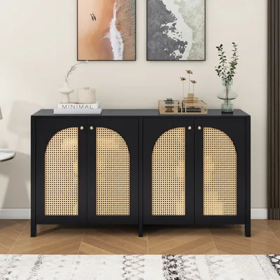A black sideboard with rattan doors is displayed in a room setting, with artwork on the wall and a rug on the floor.