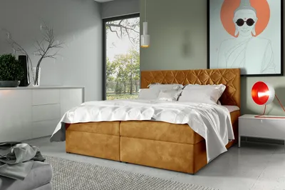 A bedroom scene with a bed, dresser, and artwork.
