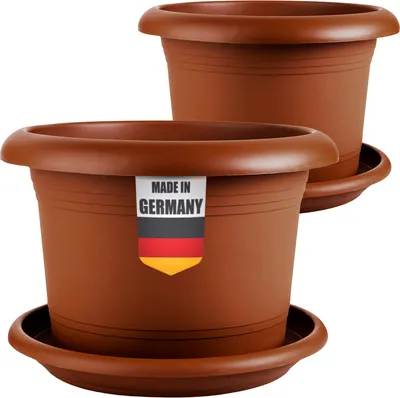 Two brown plastic plant pots with saucers are shown against a white background. A label on the front pot reads "MADE IN GERMANY" with the German flag.