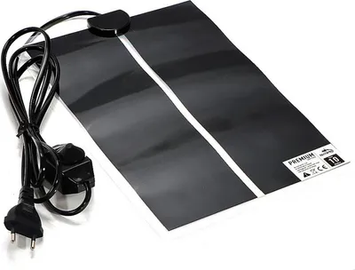 A black heating mat with a white stripe down the middle, connected to a power cord and plug.
