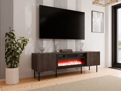 A modern living room setup featuring a TV stand with a fireplace, a large television, and a potted plant.