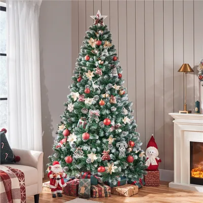 A decorated Christmas tree in a living room setting with a fireplace and furniture.