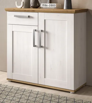 A white and wood sideboard with silver handles is shown in a room setting.