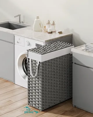 A laundry room scene with a washing machine, sink, and a SONGMICS laundry basket.