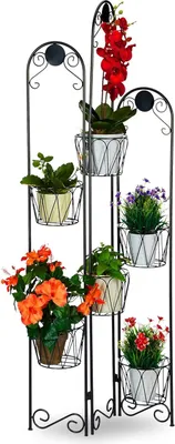 A multi-tiered metal plant stand with various potted plants.