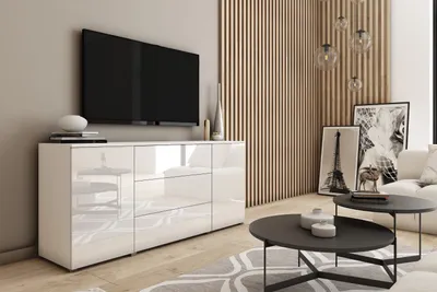 A modern living room with a white sideboard and a television.