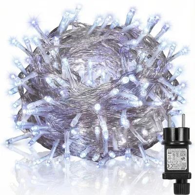 A tangled ball of white LED string lights with a black power adapter.
