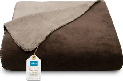 A folded blanket with a tag attached.