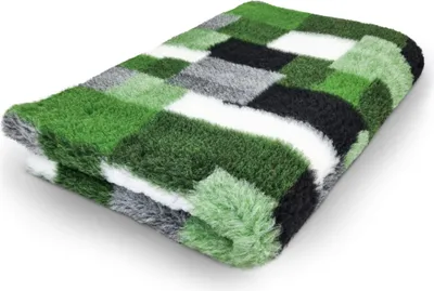 A folded pet bed with a patchwork design in shades of green, black, white, and gray.