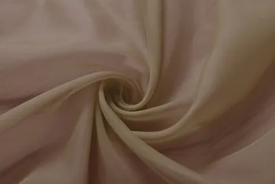 A close-up, swirled view of transparent taupe fabric.