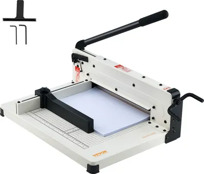 A white and black paper cutter with a stack of white paper on its cutting surface.