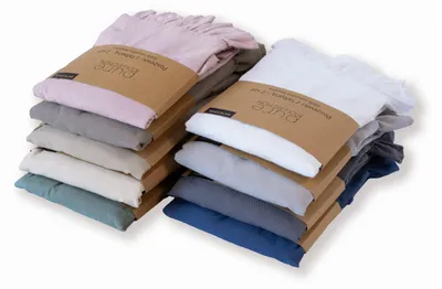 Two stacks of folded pillowcases in various colors, each with a cardboard band around the middle.
