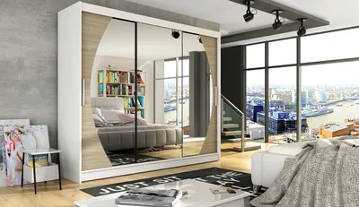 A spacious wardrobe with mirrored doors is shown in a modern bedroom with a large window overlooking a city skyline.