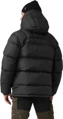 A person wearing a black puffer jacket and a black beanie, viewed from the back.