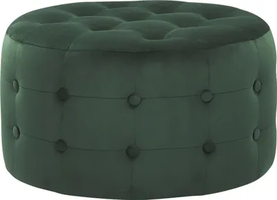 A dark green velvet ottoman with button tufting.