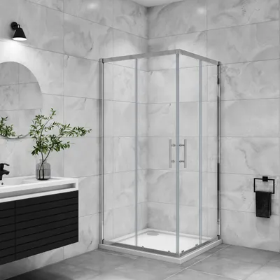 A modern bathroom with a glass shower enclosure, vanity, and sink.