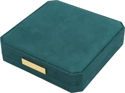 A closed jewelry box with a gold plaque on the front.