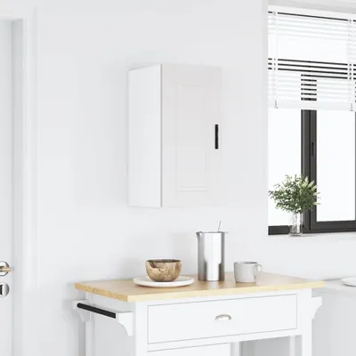 A white kitchen cabinet mounted on a white wall above a kitchen cart.