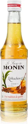 A bottle of Monin Lebkuchen syrup against a white background.