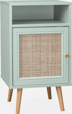 A light green nightstand with a rattan door and wooden legs, shown against a white background.