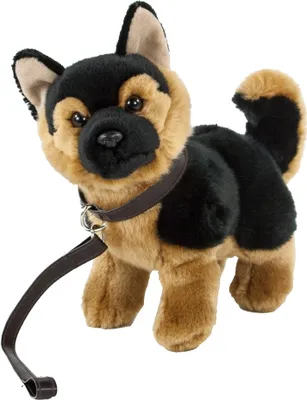 A plush toy German Shepherd dog standing with a leash.