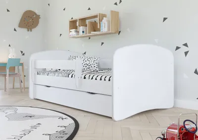 A child's bedroom with a white bed and storage drawers.