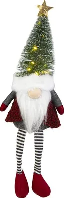 A Christmas gnome decoration with a Christmas tree for a hat, sitting with legs dangling.