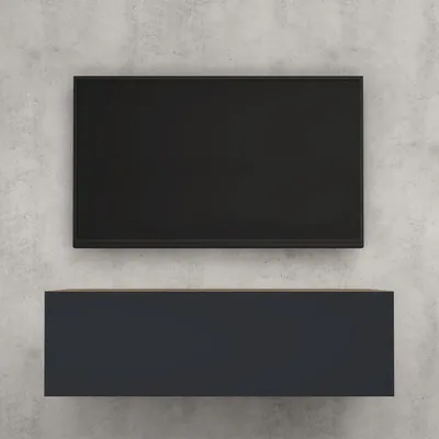 A black TV screen is mounted above a dark gray lowboard on a concrete wall.