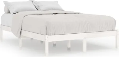A white wooden bed frame with white bedding and pillows, shown from a side angle.