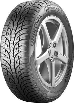 A close-up studio shot of a car tire mounted on a silver alloy wheel.