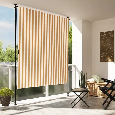A balcony with a striped awning, furniture, and plants.