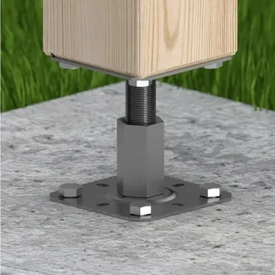 A close-up view of a metal post anchor securing a wooden post to a concrete surface, with grass in the background.