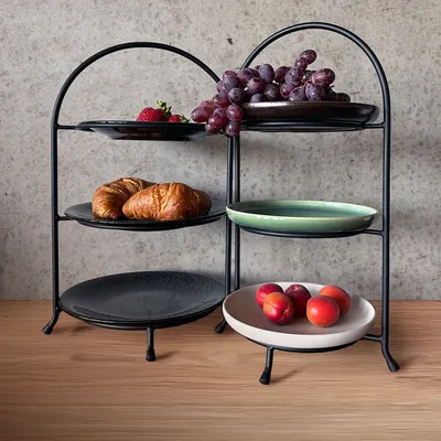 A tiered serving stand with various food items on display.