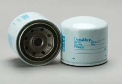 Two white oil filters are shown against a light gray background. One filter is shown from the side, with its internal filtering material visible. The other filter is shown from the top, with branding and product information printed on its side.