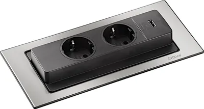 A close-up, studio shot of a retractable power outlet with two European-style sockets and a USB port, mounted on a brushed metal plate.
