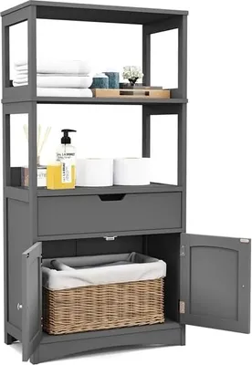 A gray freestanding bathroom cabinet with shelves, a drawer, and two doors, displaying various bathroom items.