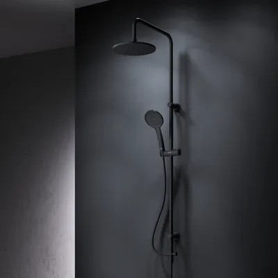 A black shower system mounted on a dark gray wall.