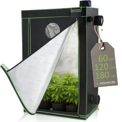 A grow tent with plants inside, with the front flap partially open.