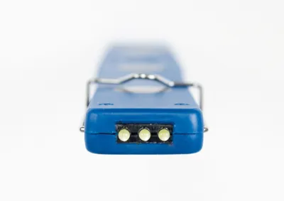 Close-up of the end of a blue LED work light with three small lights visible.
